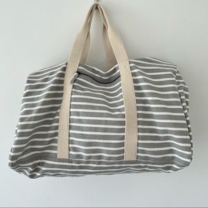 Striped gray and white weekender duffle bag.